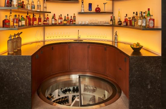 spiral wine cellar by Genuwine Cellars surrounded by bar area